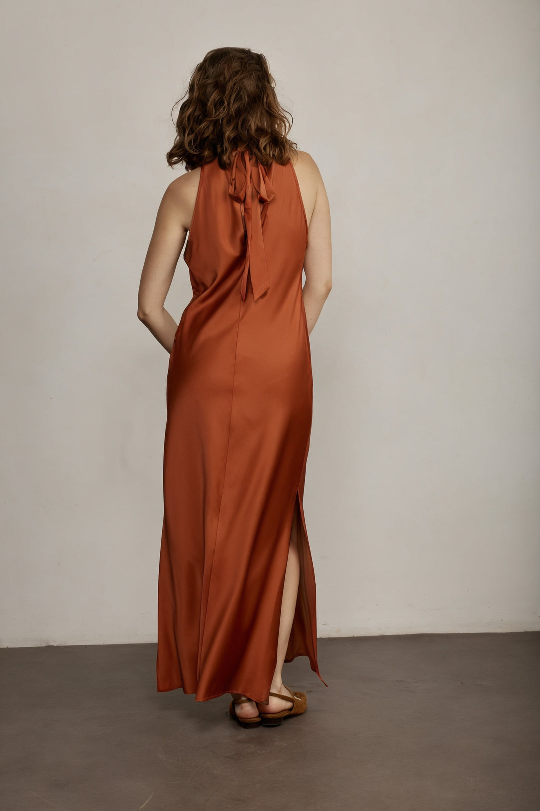 Monica שמלת ערב כתומה בגזרה קלאסית ואורך מידי בעלת צווארון עדין שנקשר בגב משכית
